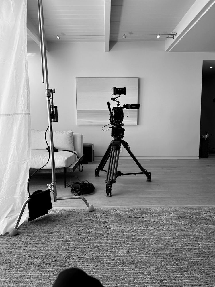 Camera on a tripod in a minimal studio
